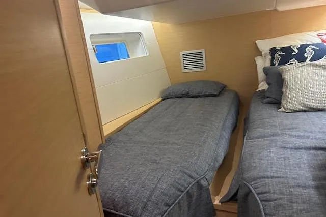 Slide: The Image of Cozy cabin interior of 2016 Jeanneau 54 yacht with twin beds and nautical decor. - 20