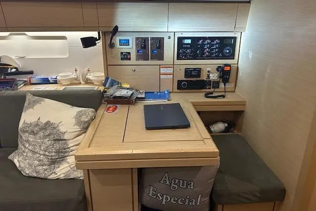 Slide: The Image of Interior of 2016 Jeanneau 54 yacht with navigation station and seating area. - 23