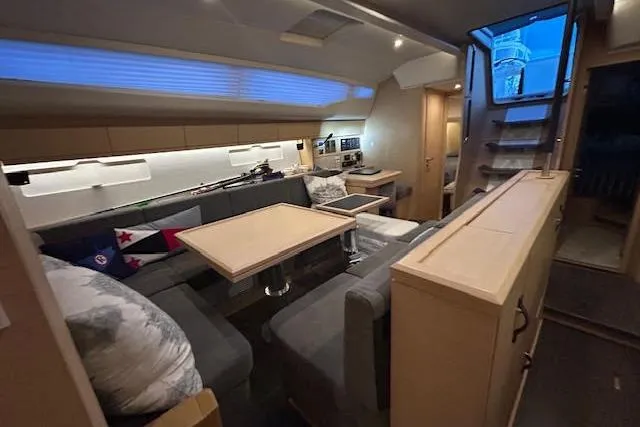 Slide: The Image of Luxurious interior of a 2016 Jeanneau 54 yacht with modern seating and dining area. - 25