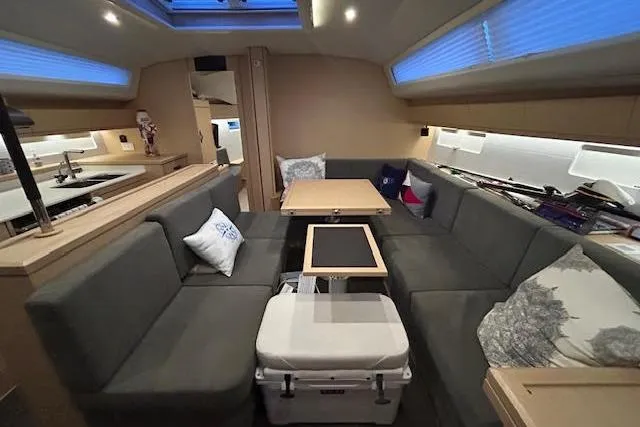 Slide: The Image of Interior of 2016 Jeanneau 54 yacht with modern seating and dining area. - 26