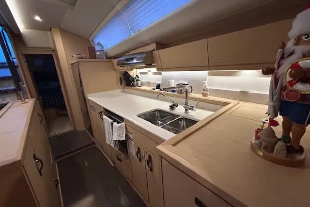 Slide: The Image of Modern kitchen interior of 2016 Jeanneau 54 yacht with sleek countertops and cabinetry. - 27