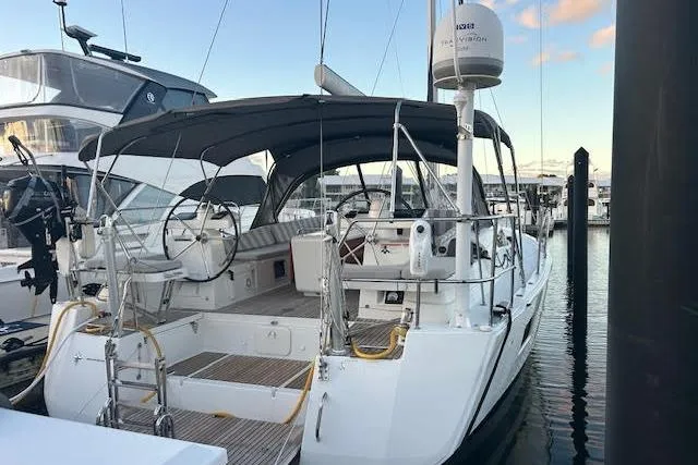 Slide: The Image of 2016 Jeanneau 54 sailboat docked, featuring a spacious cockpit and sleek design. - 32