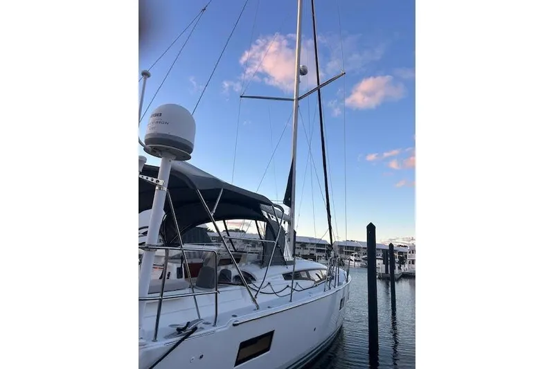 Slide: The Image of 2016 Jeanneau 54 sailboat docked at marina under blue sky. - 33