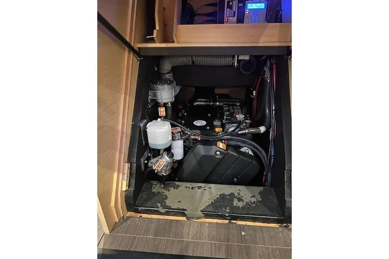 Slide: The Image of Engine compartment of a 2016 Jeanneau 54 sailboat, showcasing mechanical components and wiring. - 40