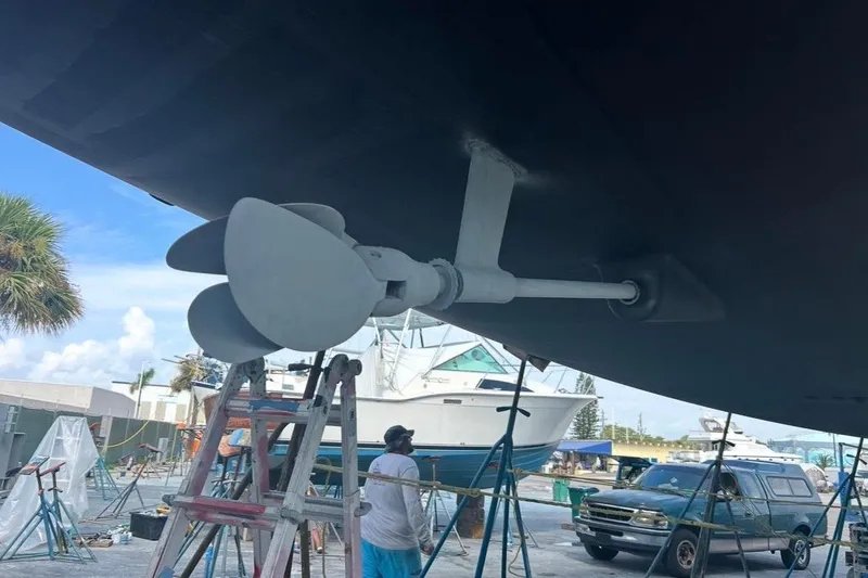 Slide: The Image of Jeanneau 54 sailboat under maintenance, showcasing propeller and hull, 2016 model. - 41