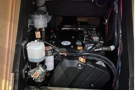 Slide: The Image of Engine compartment of a 2016 Jeanneau 54 sailboat, showcasing mechanical components and wiring. - 42