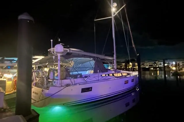 Slide: The Image of 2016 Jeanneau 54 sailboat docked at night with ambient lighting. - 43
