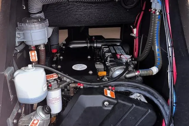 Slide: The Image of Engine compartment of a 2016 Jeanneau 54 sailboat, showcasing mechanical components and wiring. - 49