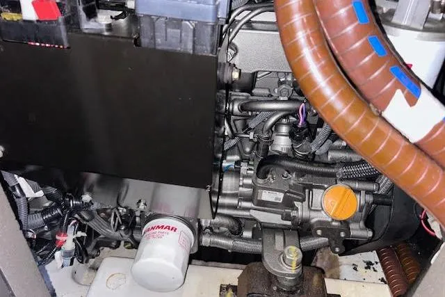 Slide: The Image of Engine compartment of a 2016 Jeanneau 54 sailboat, featuring Yanmar components and wiring. - 52