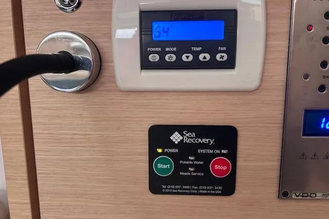 Slide: The Image of Control panel on a 2016 Jeanneau 54 yacht, featuring Sea Recovery system. - 54