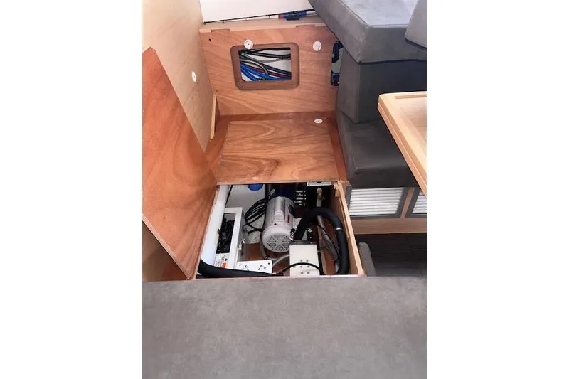 Slide: The Image of Interior view of 2016 Jeanneau 54 yacht, showcasing under-seat storage and equipment. - 57