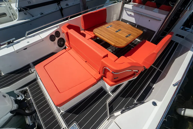 Slide: The Image of Nimbus T11 2022 with red seating and outdoor wooden table. - 16