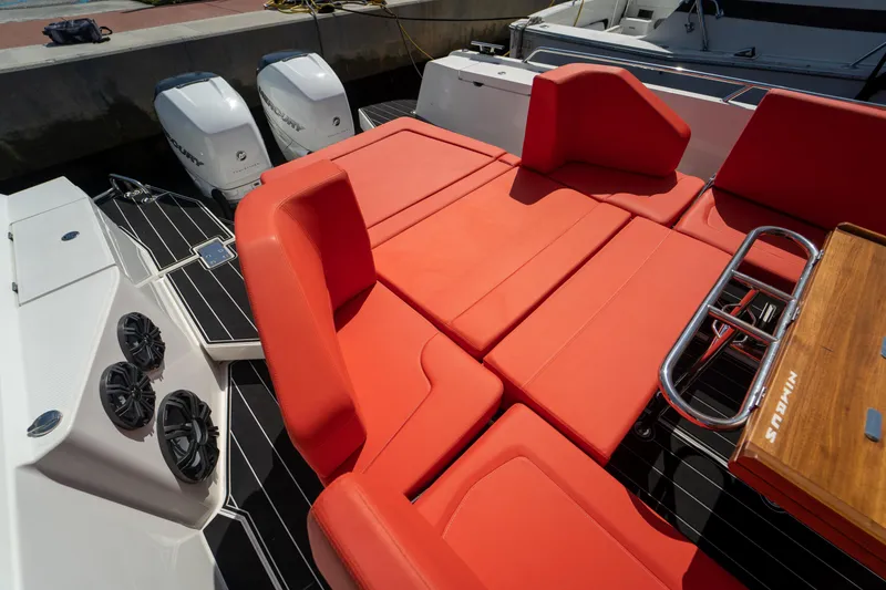 Slide: The Image of Nimbus T11 2022 with red seating and outboard motors. - 17