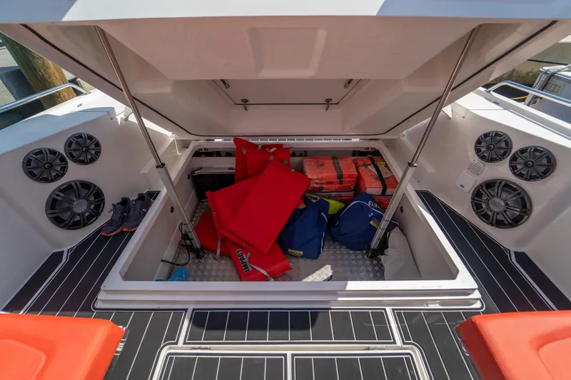 Slide: The Image of Storage compartment of a Nimbus T11 boat filled with gear. - 18