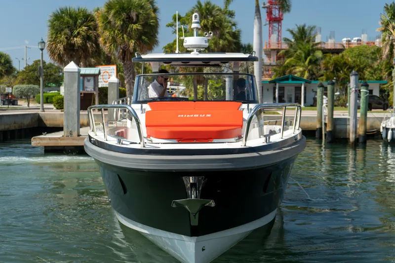 Slide: The Image of Nimbus T11 2022 boat docked at harbor with palm trees. - 2