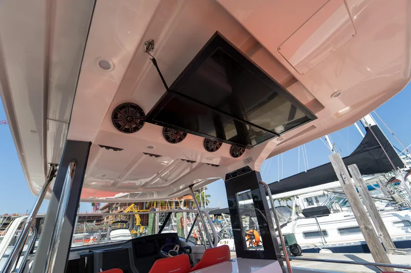 Slide: The Image of Interior view of a 2022 Nimbus T11 boat with speakers and screen. - 26