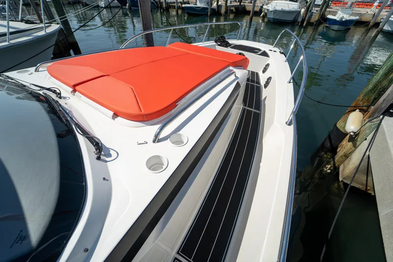 Slide: The Image of Nimbus T11 2022 boat with red sun deck in harbor. - 27