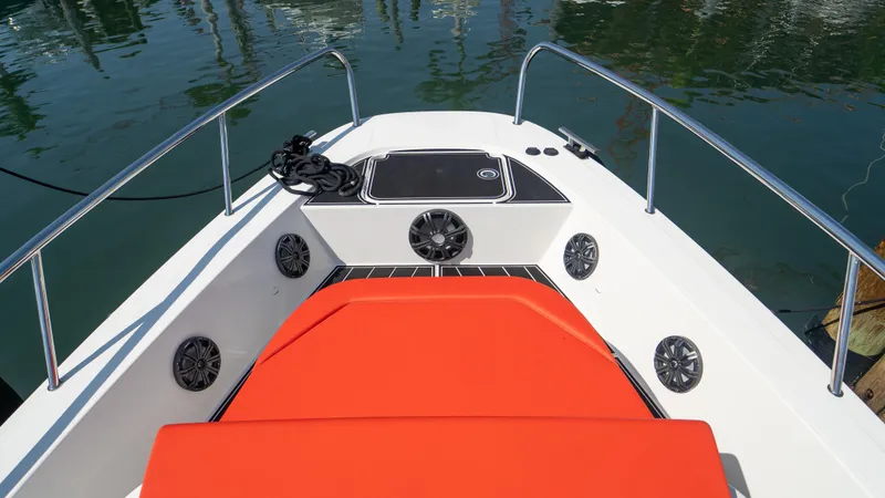 Slide: The Image of Front deck of a 2022 Nimbus T11 boat with red cushion. - 29