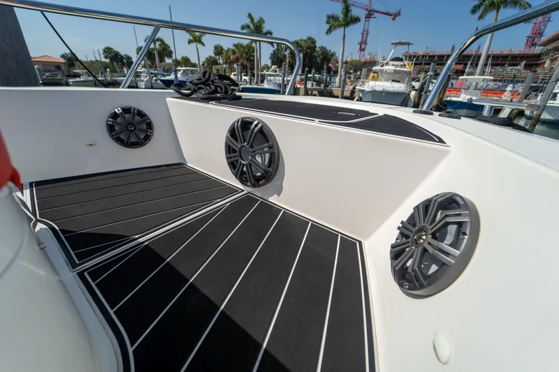 Slide: The Image of Interior of a 2022 Nimbus T11 boat with speakers and black flooring. - 30