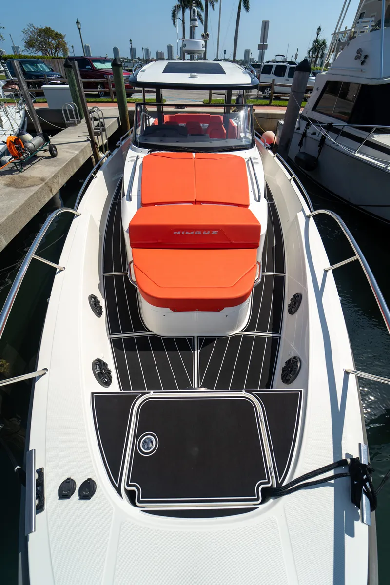 Slide: The Image of Nimbus T11 2022 boat with orange seat cushion in harbor. - 31