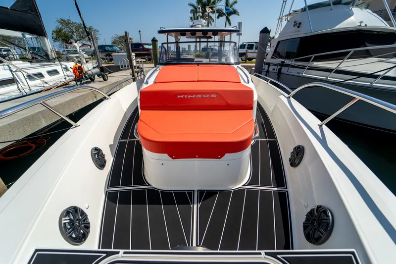 Slide: The Image of 2022 Nimbus T11 boat with red seating at the dock. - 32