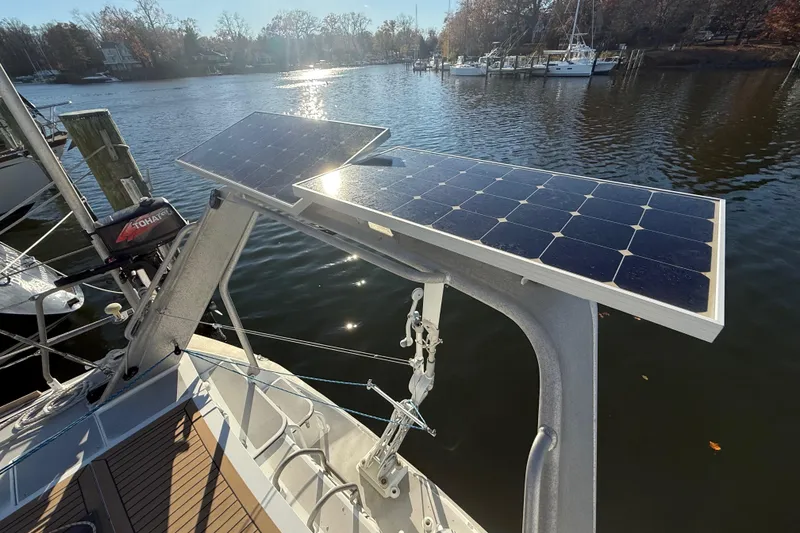 Slide: The Image of Sailboat with solar panels on a Boreal 47, 2017 model, docked by a serene lake. - 13