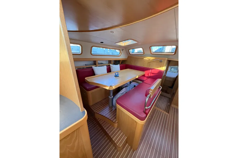 Slide: The Image of Cozy interior of 2017 Boreal 47 yacht with red seating and wooden accents. - 18
