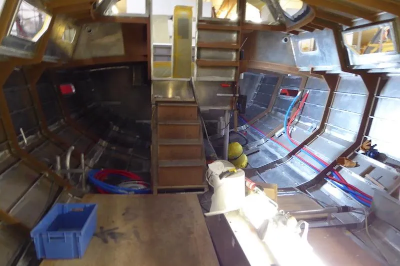 Slide: The Image of Interior of a 2017 Boreal 47 sailboat under construction, showcasing metal framework and wiring. - 32