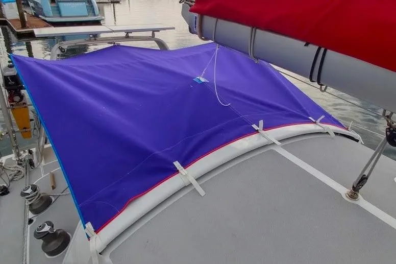 Slide: The Image of Blue and red tarp on Boreal 47 sailboat, 2017 model, docked at marina. - 6