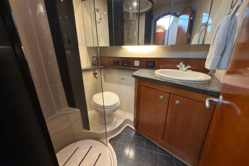 Slide: The Image of Luxurious bathroom in 2008 Cruisers 455 Motor Yacht with modern fixtures and wood cabinetry. - 24