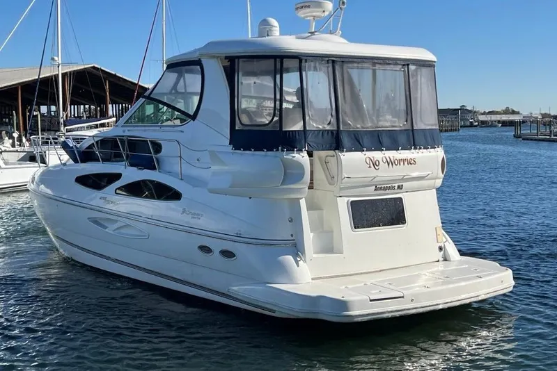 Slide: The Image of 2008 Cruisers 455 Motor Yacht docked in a marina, clear blue sky. - 6