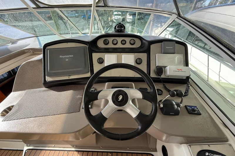 Slide: The Image of 2008 Cruisers 455 Motor Yacht helm with steering wheel, navigation equipment, and control panel. - 10