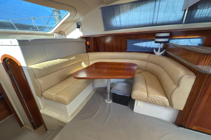 Slide: The Image of 2008 Cruisers 455 Motor Yacht interior with beige leather seating and wooden table. - 15