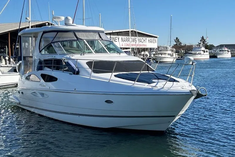 Slide: The Image of 2008 Cruisers 455 Motor Yacht docked at a marina under clear blue skies. - 3
