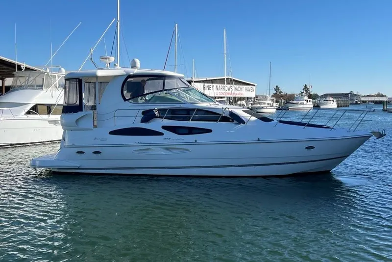 Slide: The Image of 2008 Cruisers 455 Motor Yacht docked at marina under clear blue sky. - 4