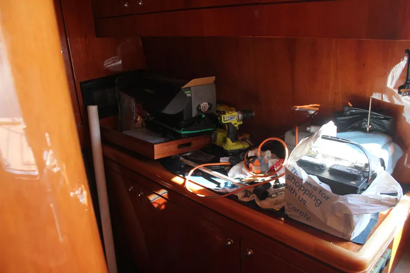 Slide: The Image of Interior of 1999 Horizon 70 Motor Yacht with tools and equipment on wooden surface. - 15