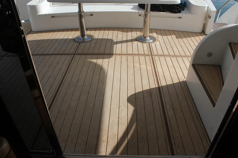 Slide: The Image of Teak deck of 1999 Horizon 70 Motor Yacht with seating and table. - 29