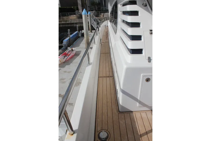 Slide: The Image of 1999 Horizon 70 Motor Yacht deck with sleek design and wooden flooring. - 31