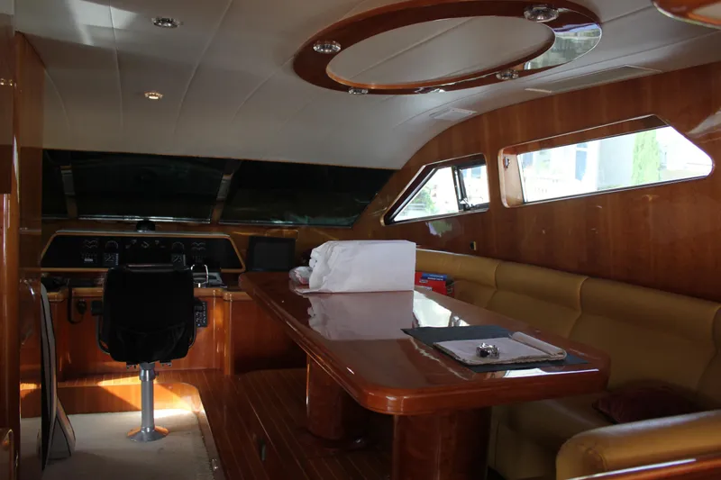 Slide: The Image of Luxurious interior of a 1999 Horizon 70 Motor Yacht with wood finishes and seating area. - 36