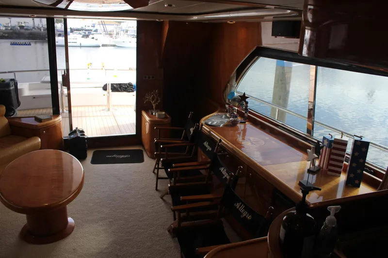 Slide: The Image of Interior of 1999 Horizon 70 Motor Yacht with elegant wood furnishings and marina view. - 38