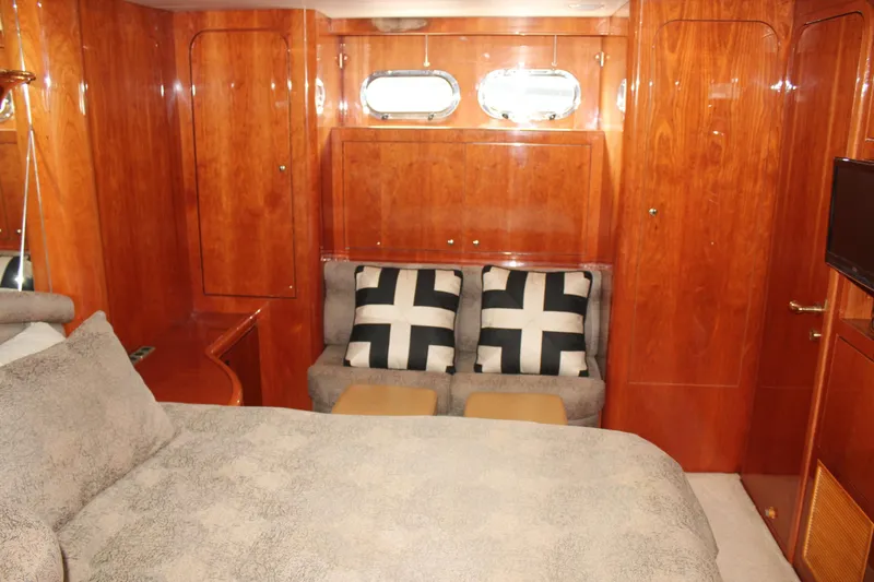 Slide: The Image of Luxurious 1999 Horizon 70 Motor Yacht cabin with wood paneling and cozy seating. - 45