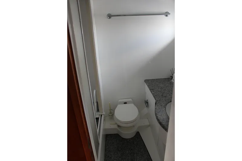 Slide: The Image of Bathroom interior of 1999 Horizon 70 Motor Yacht with toilet and granite countertop. - 46