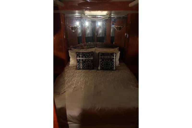 Slide: The Image of Luxurious bedroom interior of 1999 Horizon 70 Motor Yacht with elegant bedding and cushions. - 48