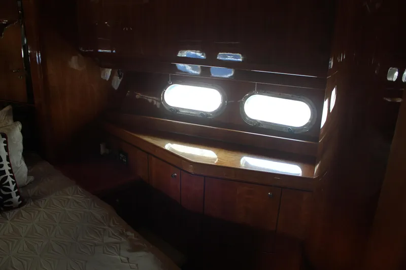 Slide: The Image of Luxurious cabin interior of 1999 Horizon 70 Motor Yacht with wooden finish and porthole windows. - 49