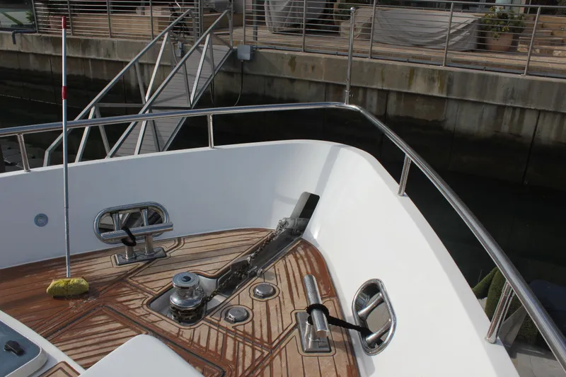 Slide: The Image of Bow deck of 1999 Horizon 70 Motor Yacht with anchor and railing. - 64