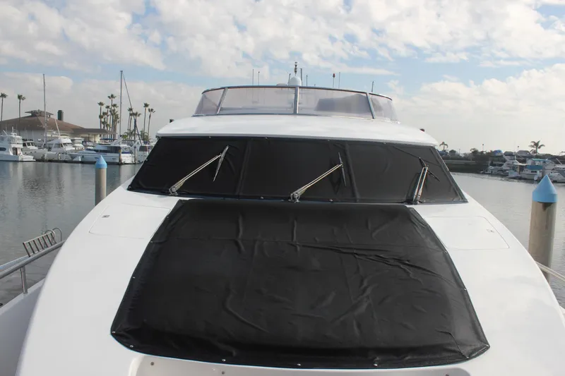 Slide: The Image of Front view of a 1999 Horizon 70 Motor Yacht docked at a marina. - 65