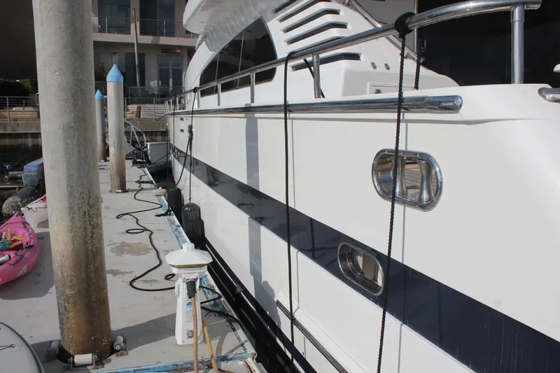 Slide: The Image of 1999 Horizon 70 Motor Yacht docked at marina, side view. - 9