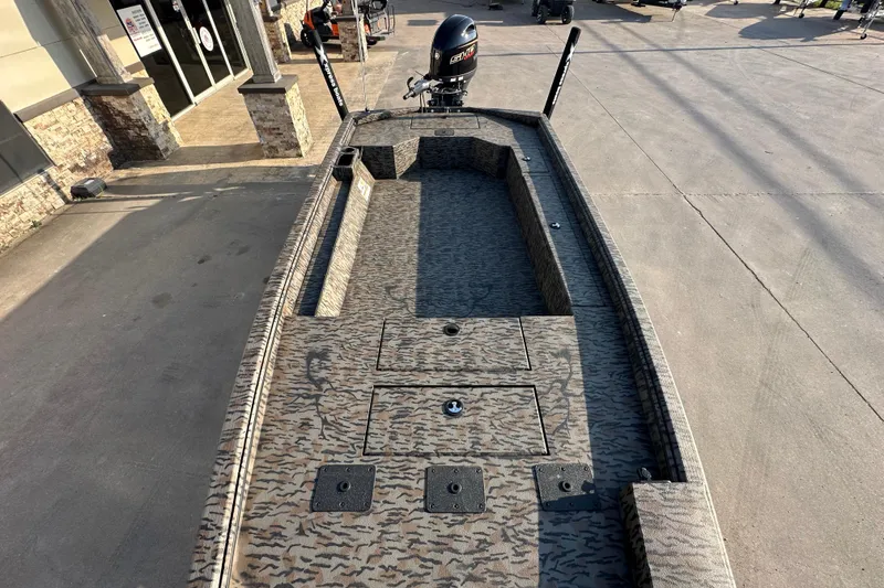 Slide: The Image of 2026 Xpress X18DB boat with camo design, parked outdoors. - 11