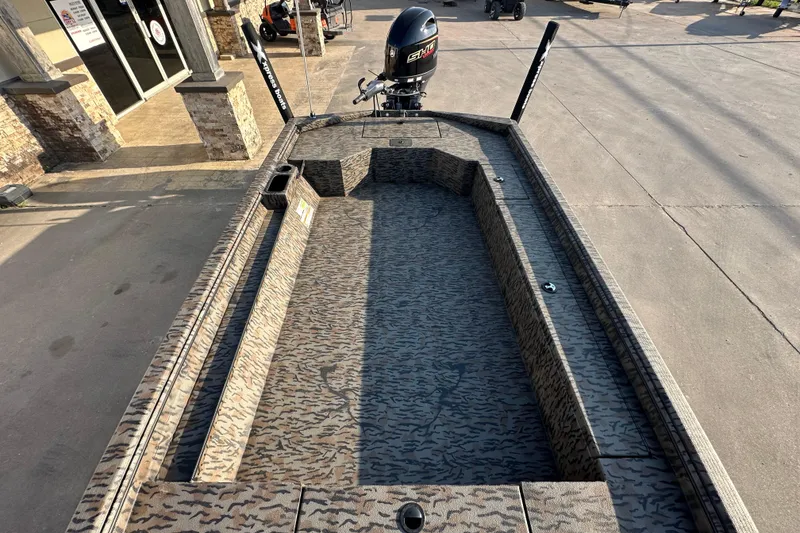 Slide: The Image of 2026 Xpress X18DB boat with camo interior and powerful outboard motor. - 12