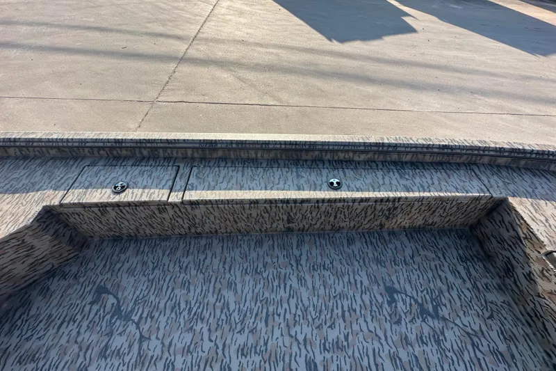 Slide: The Image of 2026 Xpress X18DB boat interior with camo pattern and storage compartments. - 14